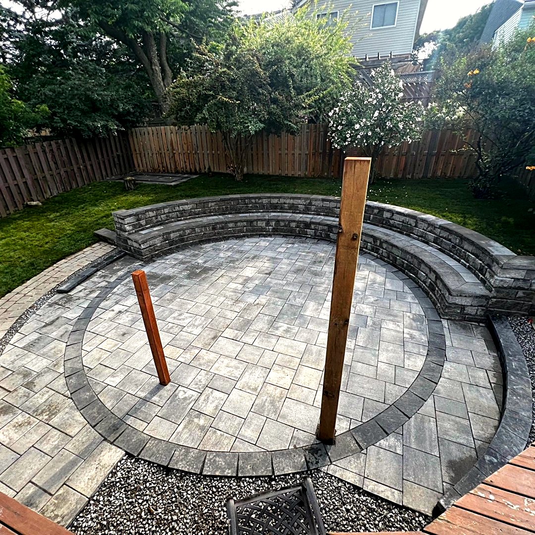 Circular paver patio with curved stone seating wall