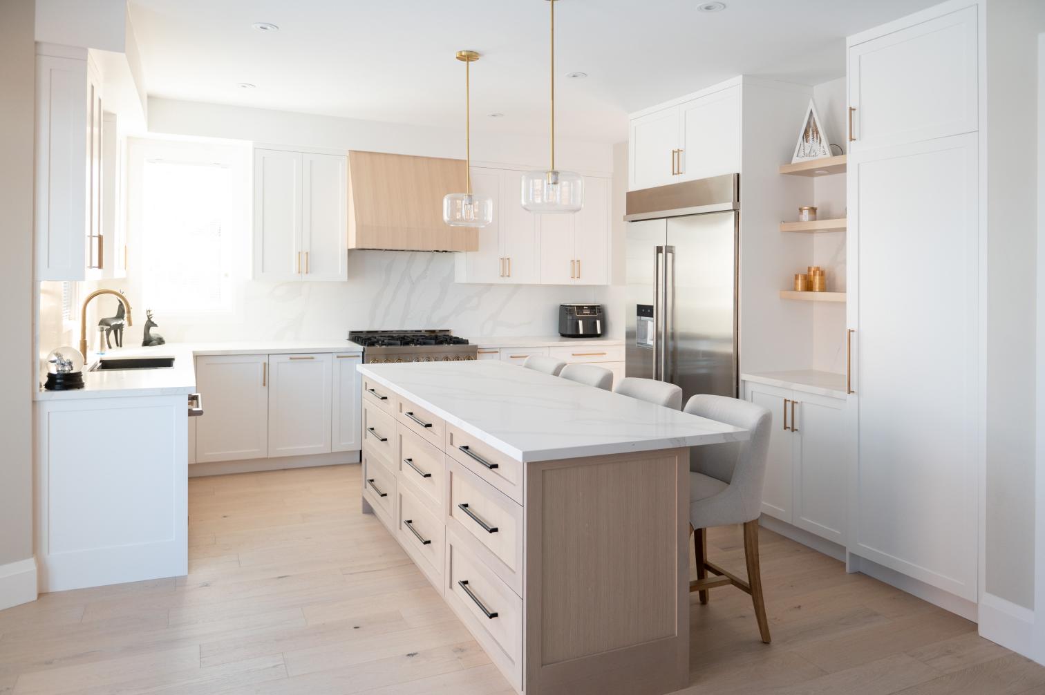 Custom white kitchen with white oak island and quartz counters in Whitby, Ontario